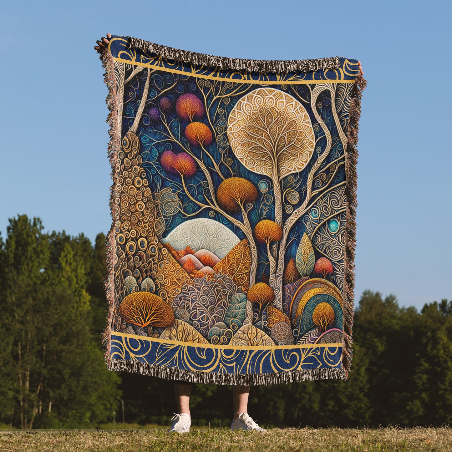 Woman holding a woven blanket of an abstract landscape