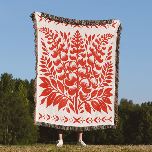 Woven blanket with red bluebonnet design